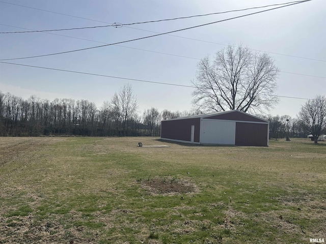 view of yard with a garage, an outbuilding, and an outdoor structure