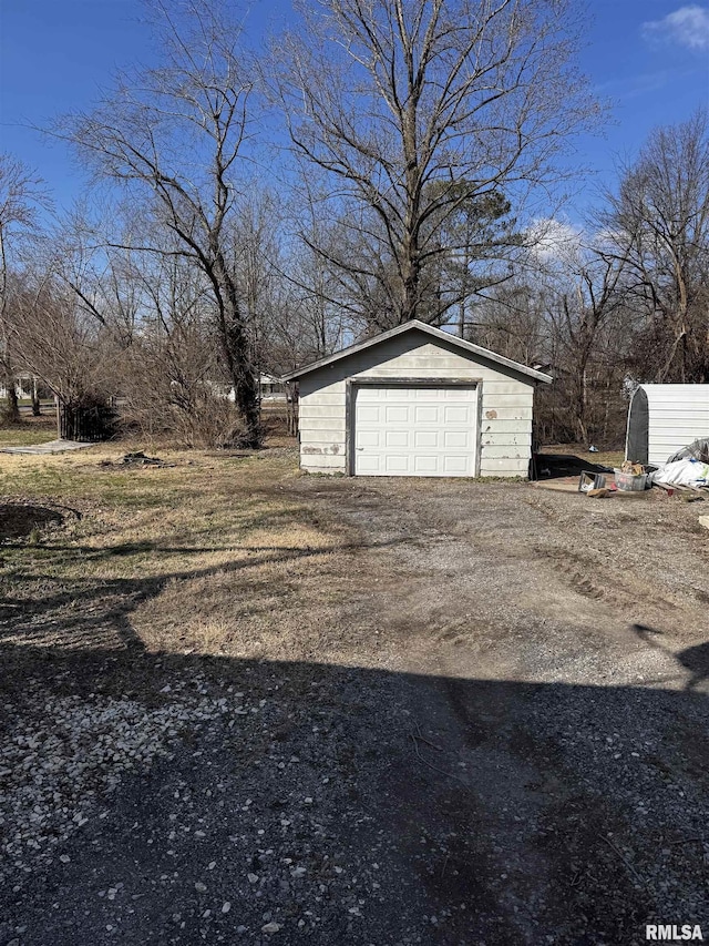 detached garage featuring driveway