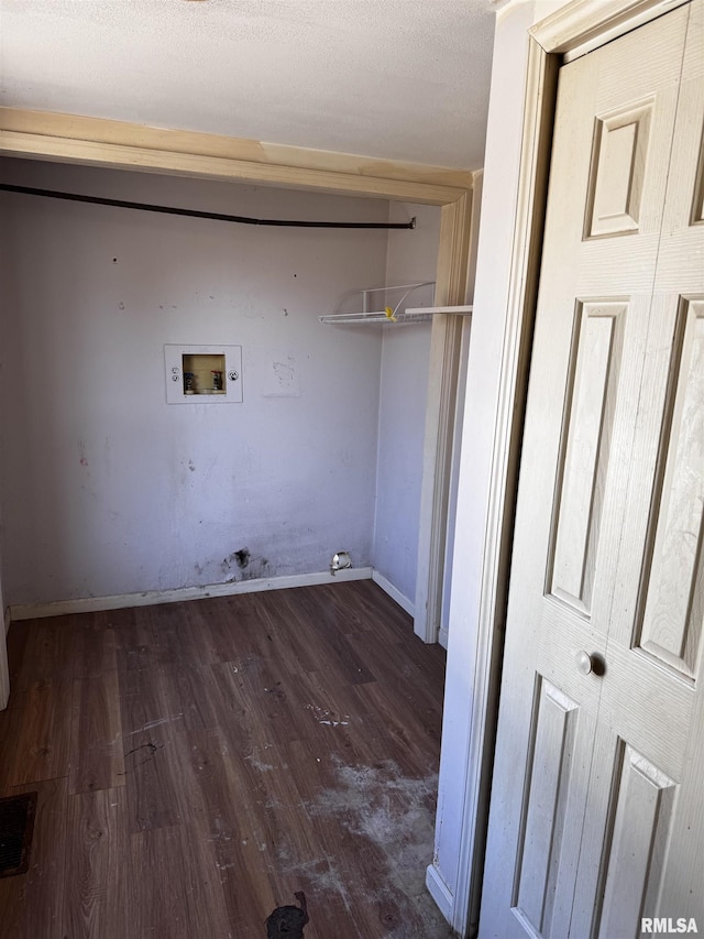 washroom featuring a textured ceiling, hookup for a washing machine, laundry area, wood finished floors, and baseboards