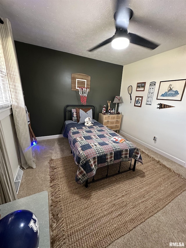 bedroom with carpet floors, baseboards, and a textured ceiling