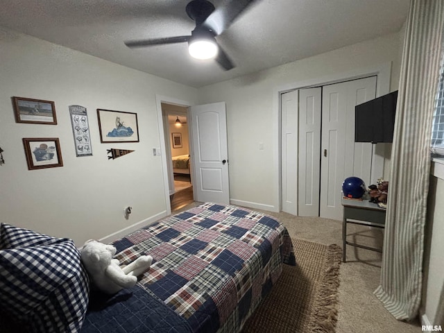 bedroom with carpet floors, a closet, baseboards, and a ceiling fan