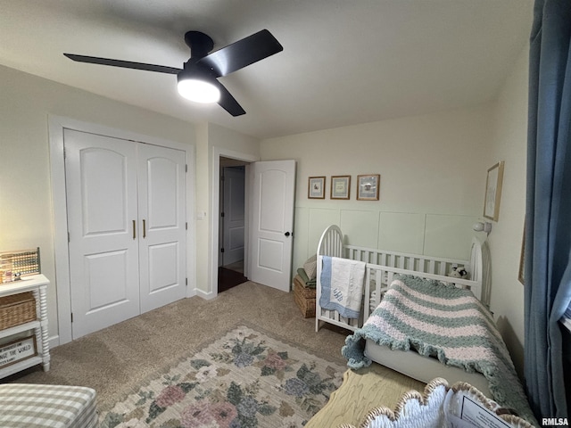 bedroom featuring ceiling fan, a closet, and carpet flooring