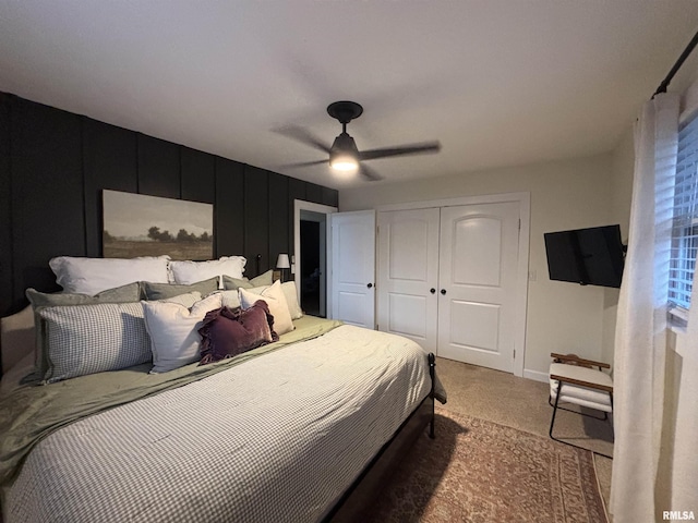 carpeted bedroom featuring baseboards, a ceiling fan, and a closet