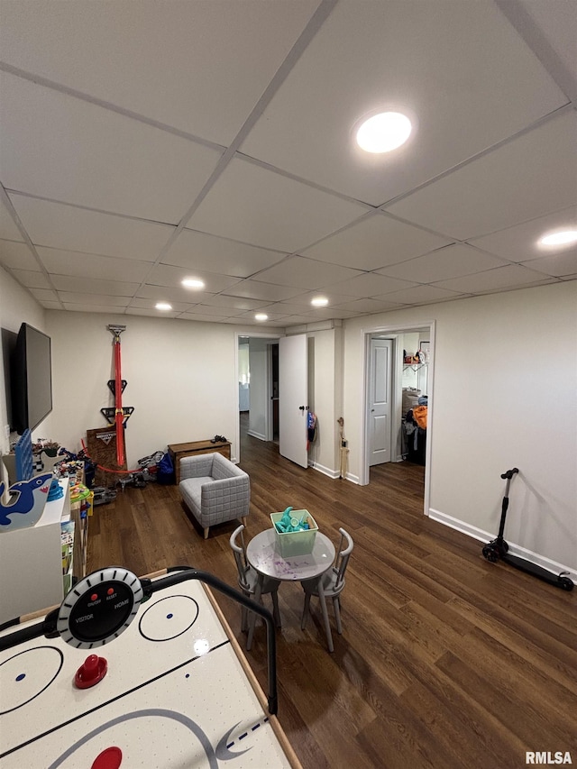 game room featuring a paneled ceiling, baseboards, wood finished floors, and recessed lighting