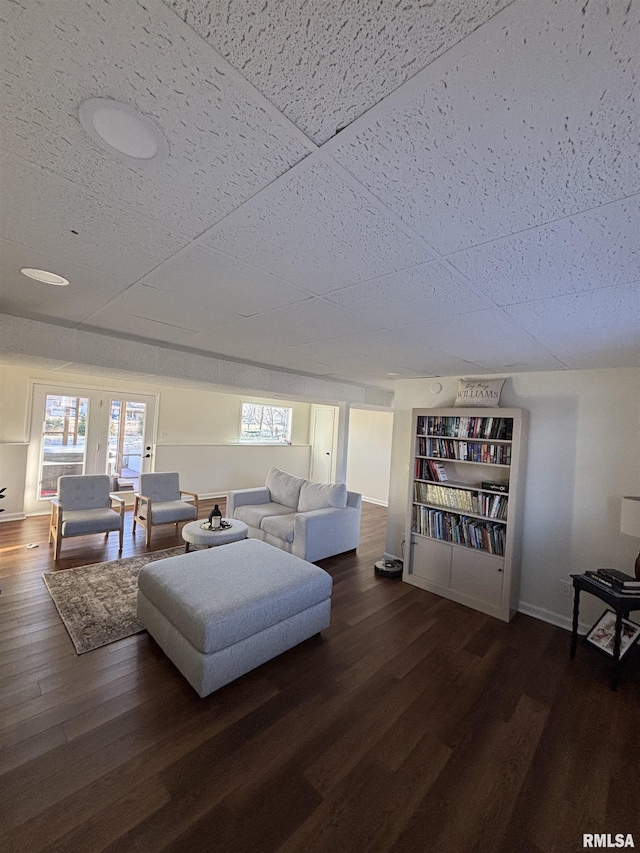 living room with baseboards and wood finished floors