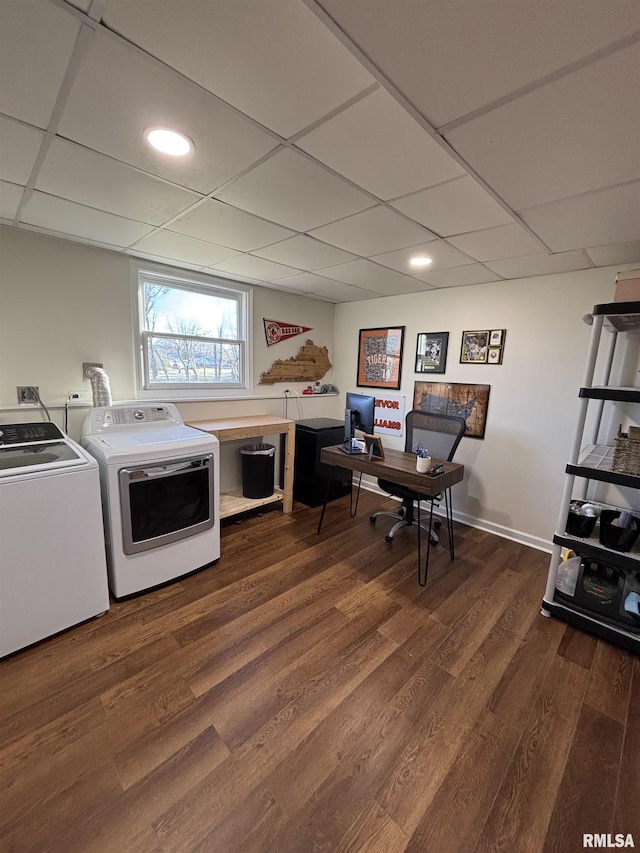 laundry room with dark wood-style floors, washing machine and dryer, laundry area, and baseboards