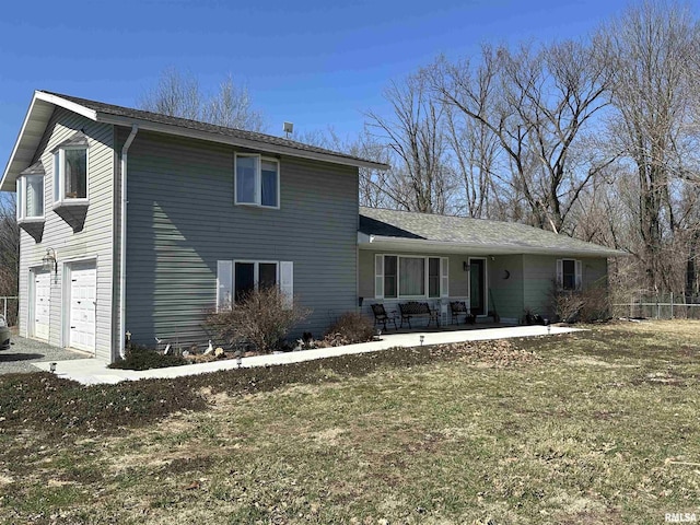 traditional home featuring an attached garage and fence