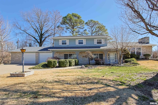 traditional home featuring a porch, an attached garage, stone siding, driveway, and a front lawn