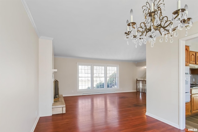 unfurnished living room featuring ornamental molding, a fireplace, wood finished floors, and baseboards