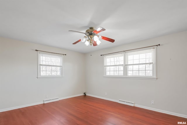 unfurnished room with visible vents, a wealth of natural light, and wood finished floors