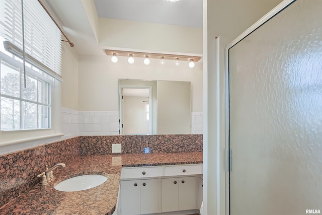 full bath featuring a stall shower and vanity