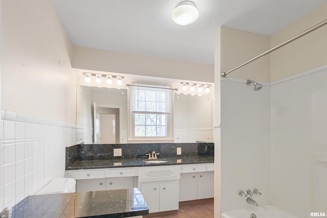 bathroom with shower / bath combination, tile patterned floors, tasteful backsplash, and vanity