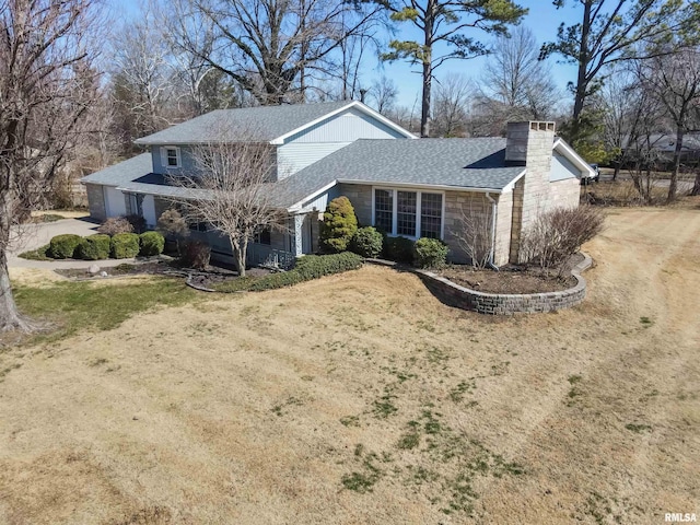 view of side of home featuring a shingled roof, a chimney, and dirt driveway