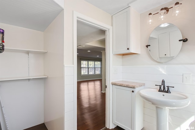 bathroom featuring wainscoting, visible vents, and wood finished floors