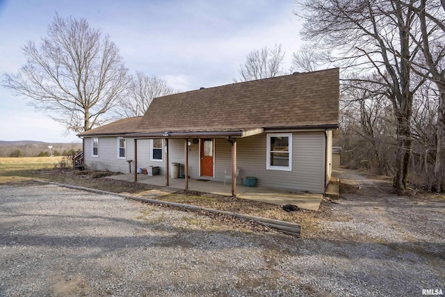 view of front of house featuring a shingled roof and a porch