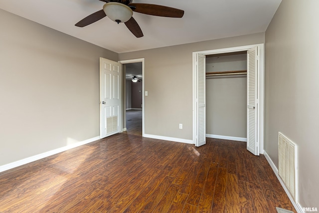 unfurnished bedroom with ceiling fan, wood finished floors, visible vents, baseboards, and a closet