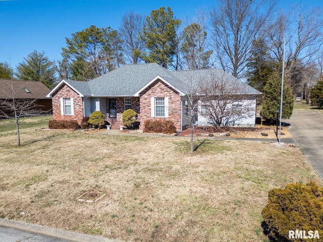 ranch-style house featuring a front lawn, brick siding, and a shingled roof