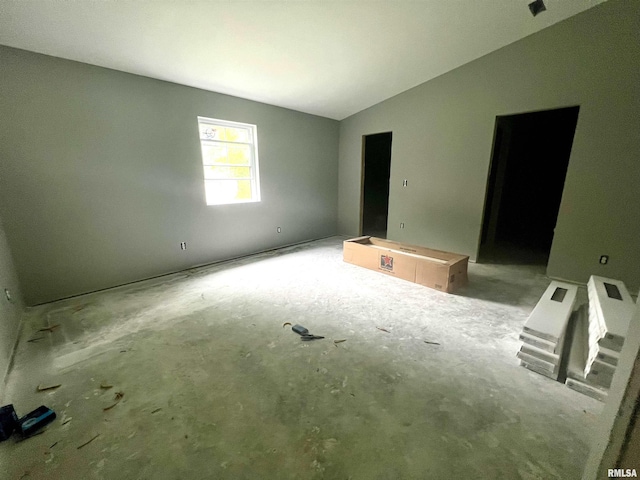 spare room featuring vaulted ceiling