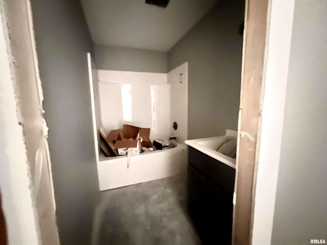 full bathroom featuring vanity and unfinished concrete floors