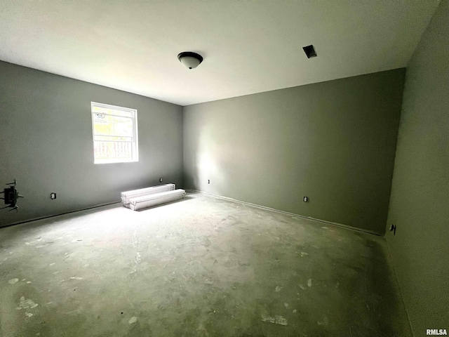 spare room with concrete flooring