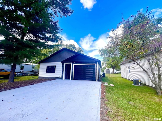 garage featuring central air condition unit and driveway