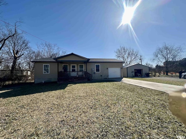 view of front of house with a front lawn, an attached garage, covered porch, and driveway