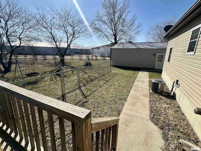 view of yard with central air condition unit and fence