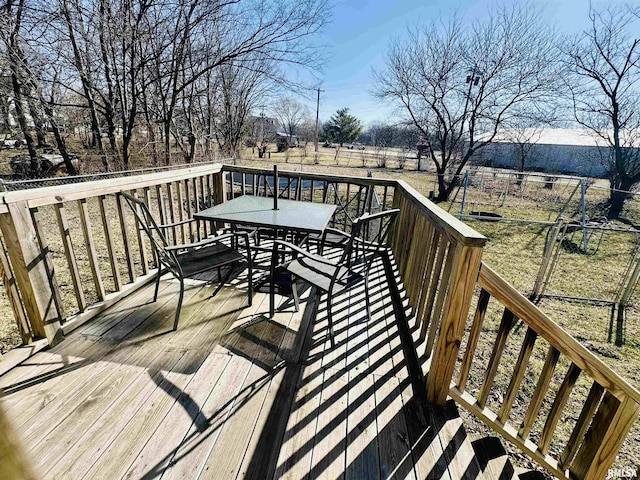 deck featuring outdoor dining space and fence