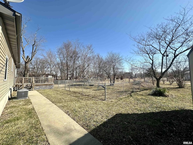 view of yard featuring central AC unit, a deck, and fence