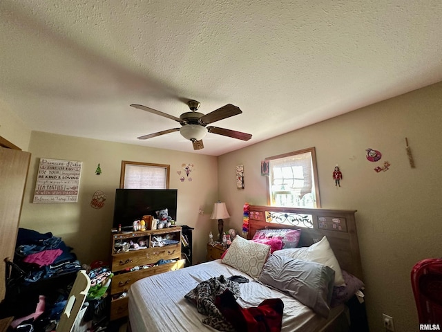 bedroom featuring a ceiling fan and a textured ceiling