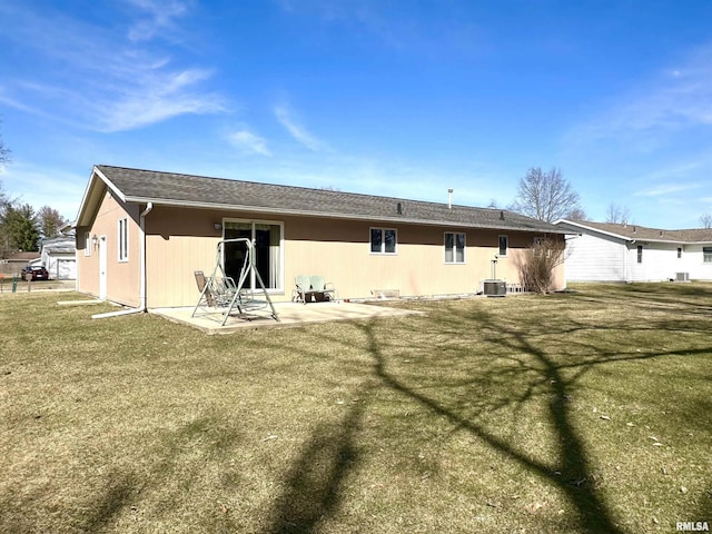 back of property with a yard, a patio, and central air condition unit