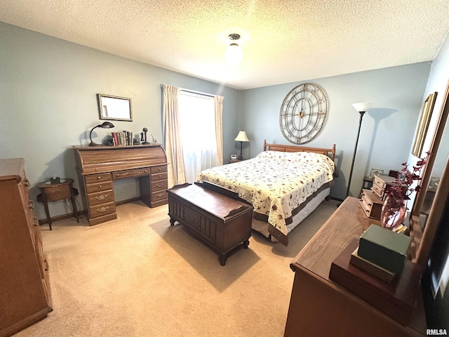 bedroom with a textured ceiling and light carpet