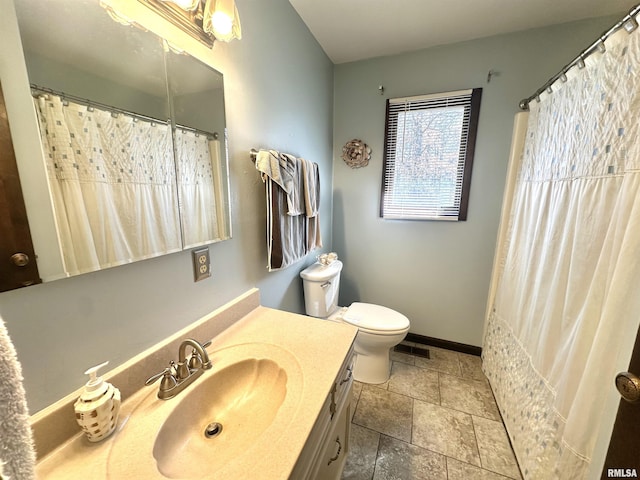 bathroom with visible vents, baseboards, toilet, and vanity