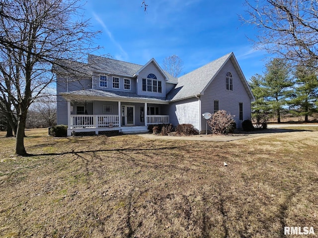 view of front of property with covered porch and a front lawn