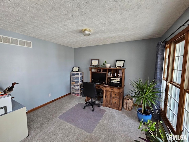 home office with visible vents, carpet flooring, a textured ceiling, and baseboards