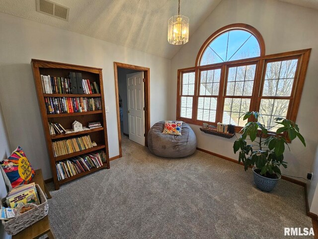 sitting room with baseboards, visible vents, carpet floors, vaulted ceiling, and a chandelier