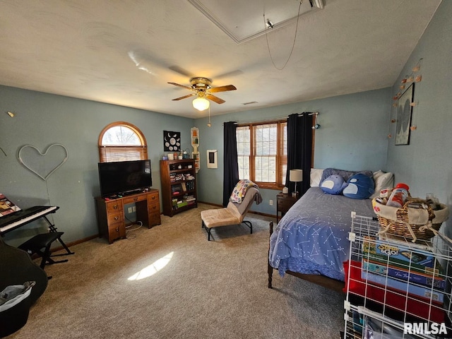 bedroom featuring attic access, carpet flooring, a ceiling fan, and baseboards