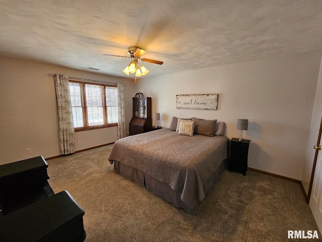 bedroom featuring a textured ceiling, baseboards, and carpet