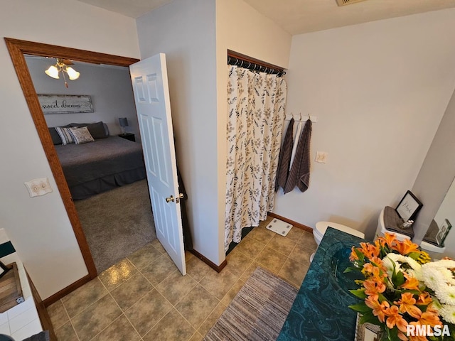 full bathroom featuring curtained shower, toilet, baseboards, and tile patterned flooring