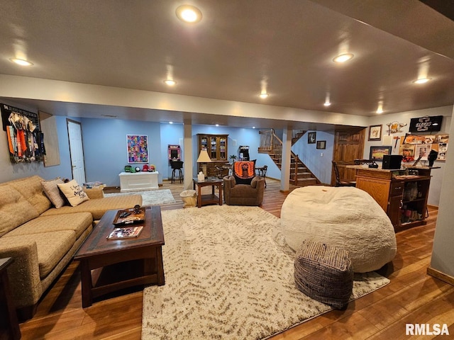 living area featuring stairs, recessed lighting, and wood finished floors