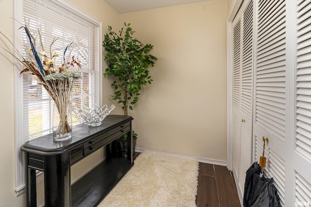 interior space with wood finished floors and baseboards