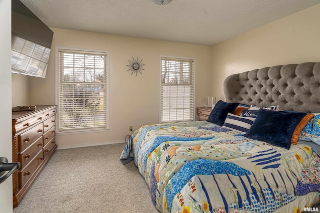 carpeted bedroom with baseboards and a textured ceiling