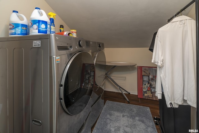 washroom featuring laundry area, washing machine and dryer, baseboards, and wood finished floors