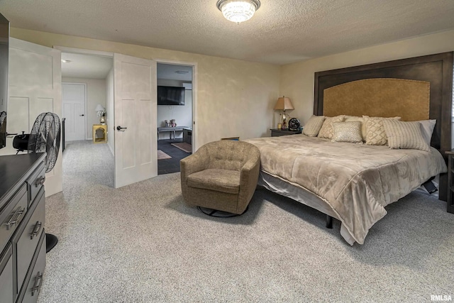 bedroom with carpet flooring and a textured ceiling