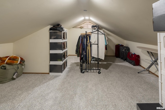 workout area with vaulted ceiling, baseboards, and carpet floors