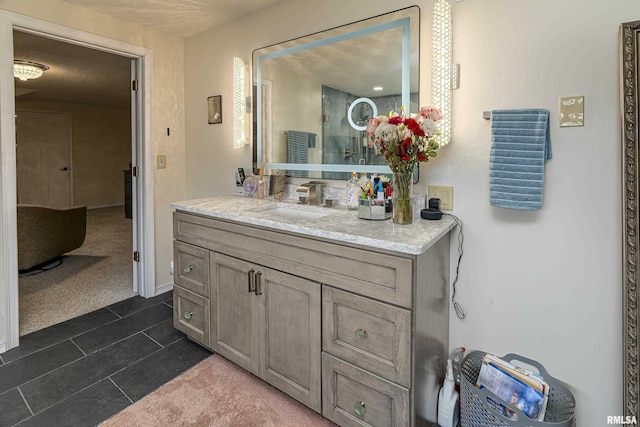 bathroom with a textured ceiling and vanity