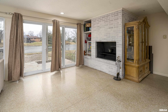 unfurnished living room featuring baseboards, recessed lighting, a fireplace, a textured ceiling, and speckled floor