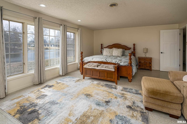 bedroom with visible vents, recessed lighting, and a textured ceiling