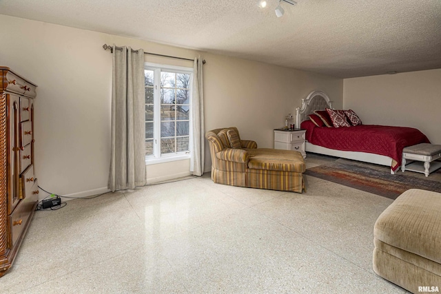 bedroom with speckled floor and a textured ceiling