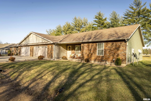 view of front of property with an attached garage, concrete driveway, and a front yard